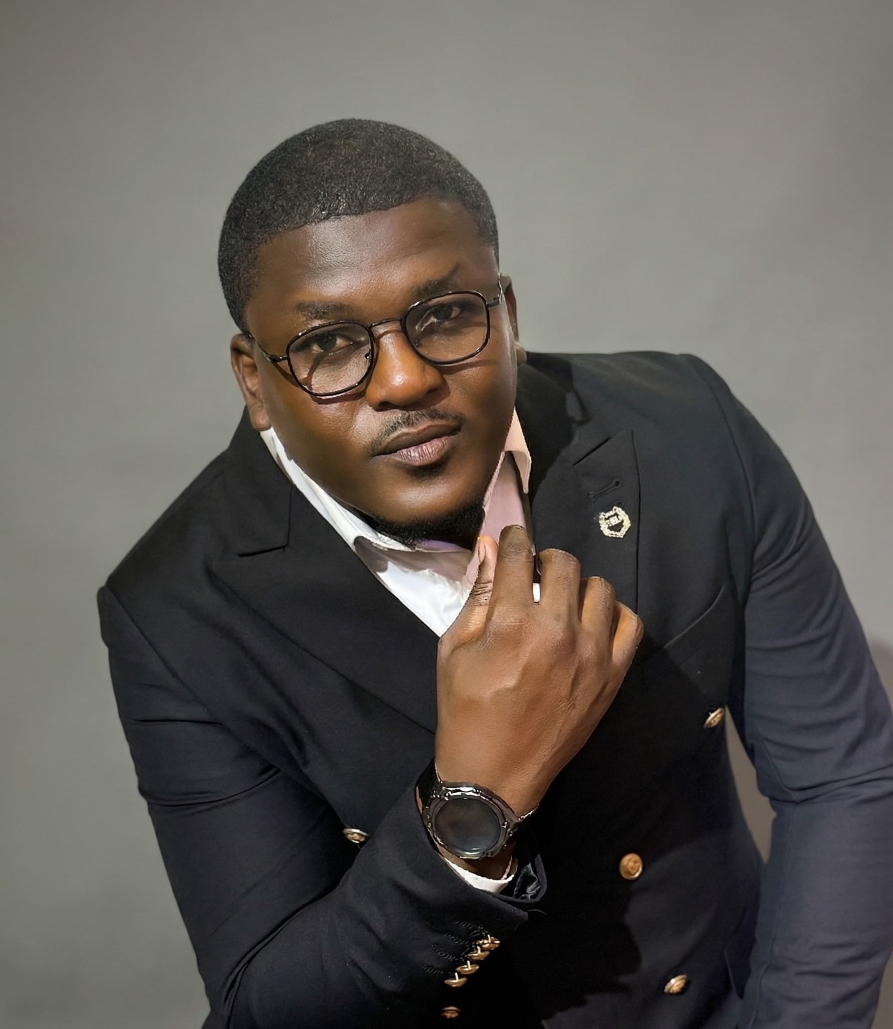 Adebayo Chike, studio portrait in a dark suit