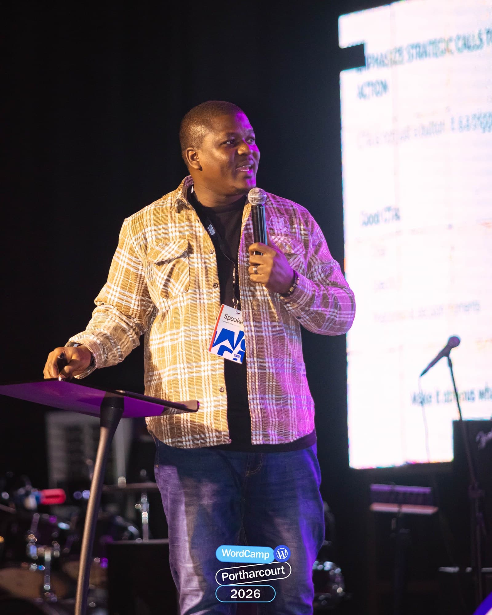 Adebayo Chike speaking at a podium at WordCamp Port Harcourt