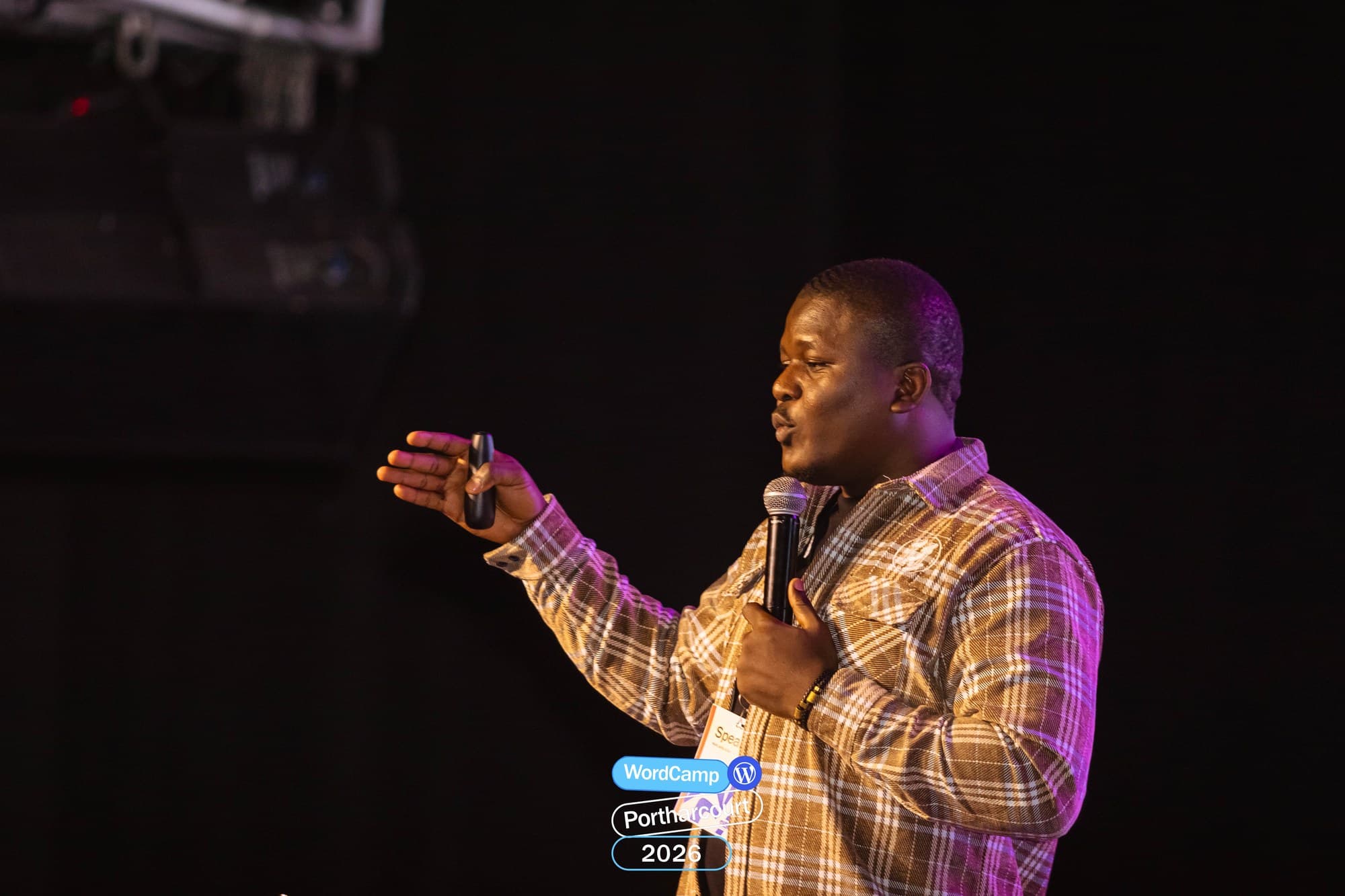 Adebayo Chike mid-explanation, microphone in hand